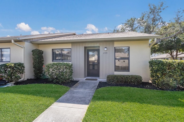 doorway to property featuring a yard