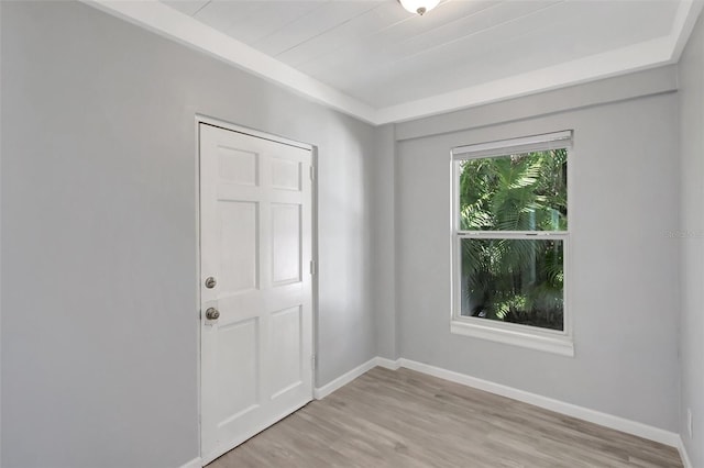 unfurnished room featuring light wood finished floors and baseboards