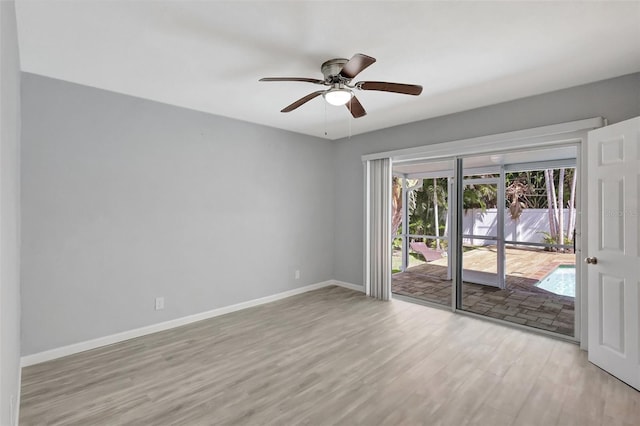 spare room with a ceiling fan, baseboards, and wood finished floors