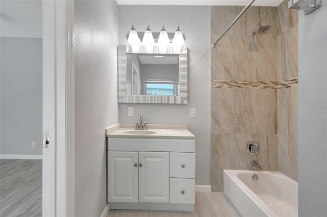 bathroom with vanity, baseboards, and shower / bathtub combination