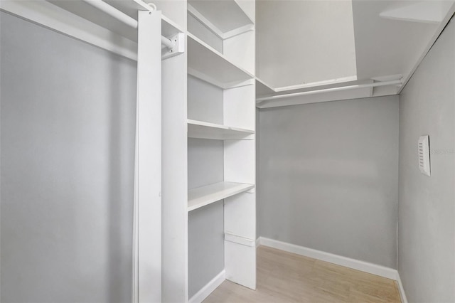 spacious closet with light wood-style floors