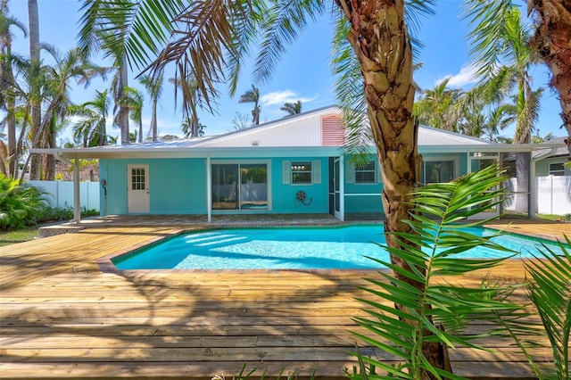 view of pool with a fenced in pool, fence, and a wooden deck