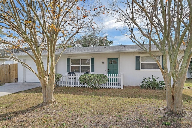 ranch-style home with a garage and a front lawn