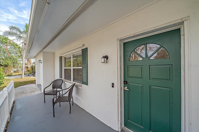 view of exterior entry with covered porch