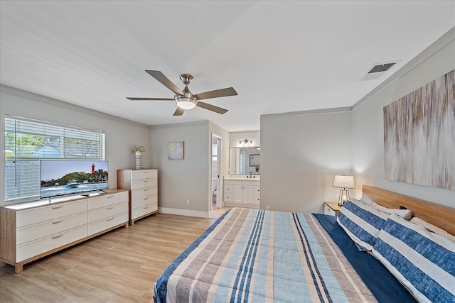 bedroom with ceiling fan, ornamental molding, connected bathroom, and light hardwood / wood-style flooring