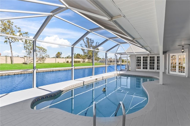 view of swimming pool with a water view, a lanai, french doors, and a patio area