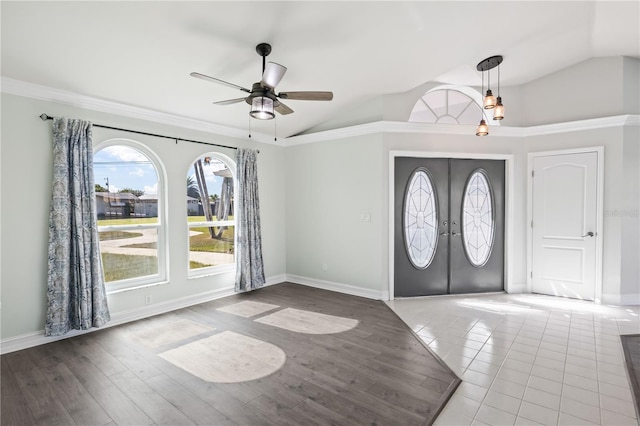 foyer with french doors, wood finished floors, baseboards, and vaulted ceiling