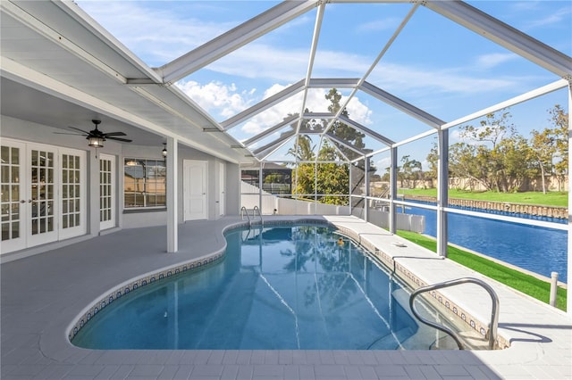 pool with a water view, ceiling fan, a patio, french doors, and a lanai