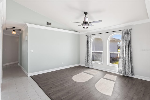 spare room with visible vents, ceiling fan, baseboards, lofted ceiling, and wood finished floors