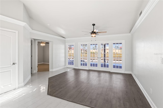 empty room featuring vaulted ceiling, crown molding, a ceiling fan, and baseboards