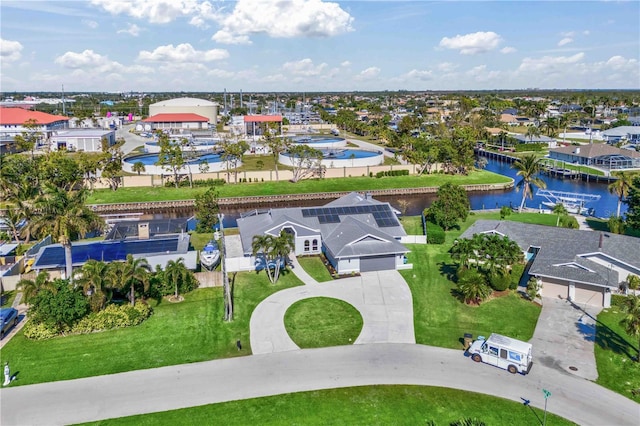 drone / aerial view with a water view and a residential view