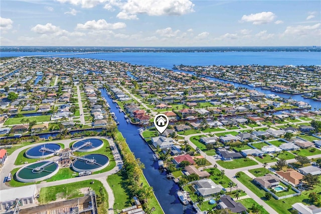 drone / aerial view with a residential view and a water view