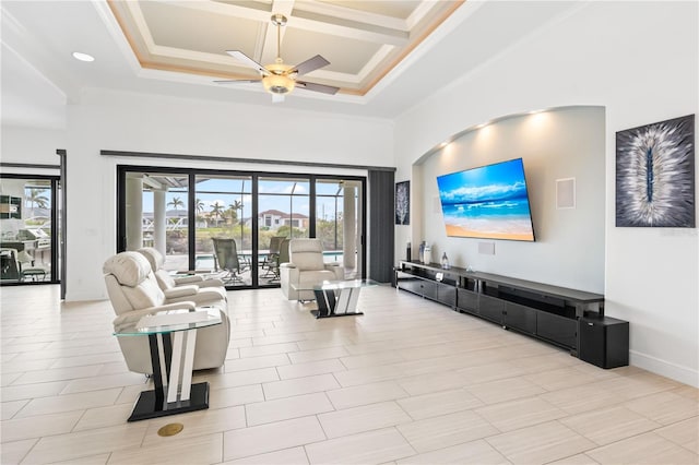 living room with a high ceiling, crown molding, coffered ceiling, and ceiling fan