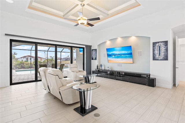 living room featuring crown molding, ceiling fan, beam ceiling, a high ceiling, and coffered ceiling