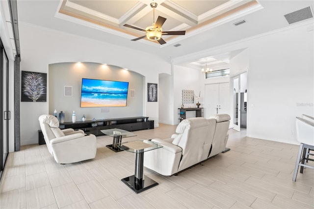 living room with crown molding, coffered ceiling, ceiling fan with notable chandelier, and beam ceiling