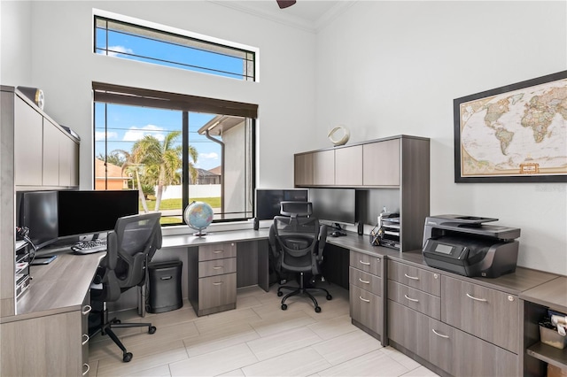 office area with a high ceiling and ornamental molding