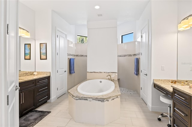 bathroom with vanity and a washtub