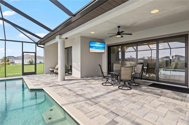 exterior space with ceiling fan, a pool, and a skylight