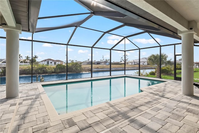 view of pool with a lanai, a patio, and a water view