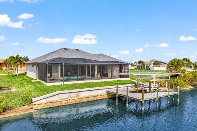 back of house featuring a yard, a lanai, and a water view