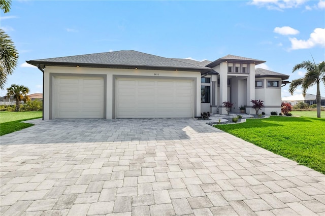 prairie-style home with a garage and a front lawn