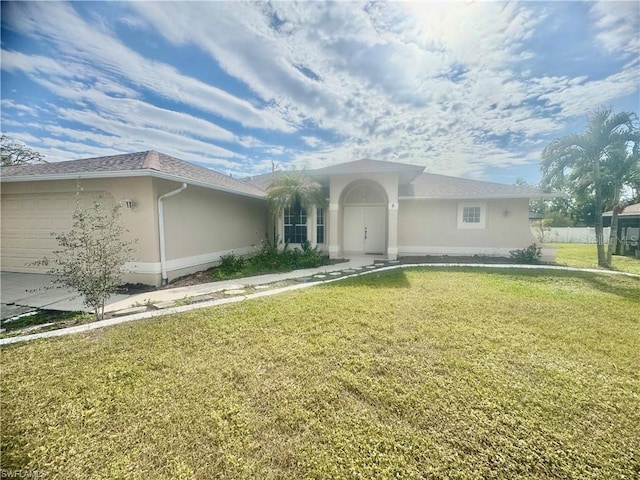 ranch-style house with a garage and a front lawn