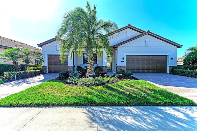 view of front of home with a garage and a front lawn