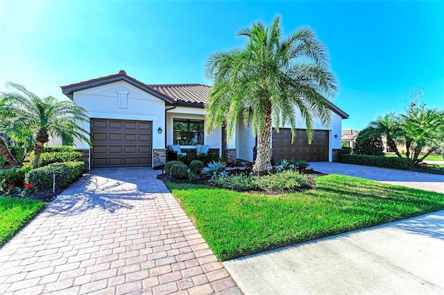 view of front facade featuring a garage and a front lawn