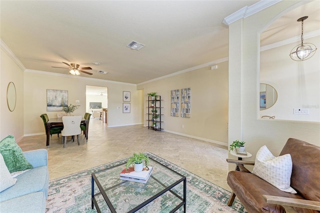 tiled living room with ornamental molding and ceiling fan with notable chandelier