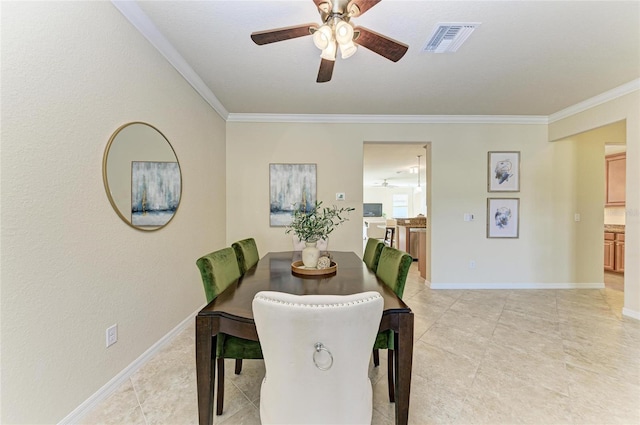 tiled dining room featuring ornamental molding and ceiling fan