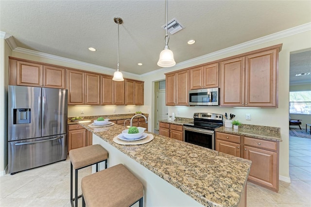 kitchen featuring a kitchen bar, light stone counters, decorative light fixtures, ornamental molding, and stainless steel appliances