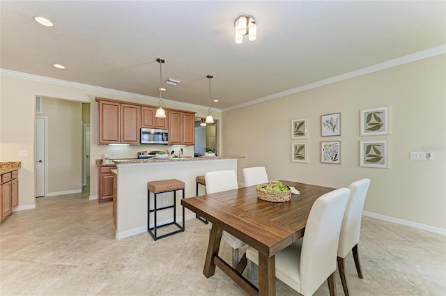 tiled dining room featuring crown molding