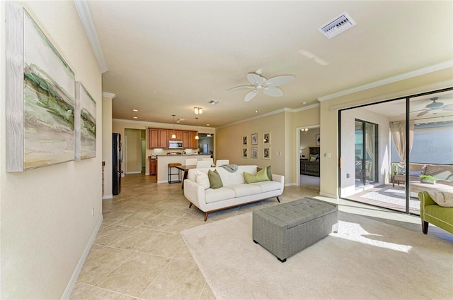 tiled living room with crown molding and ceiling fan