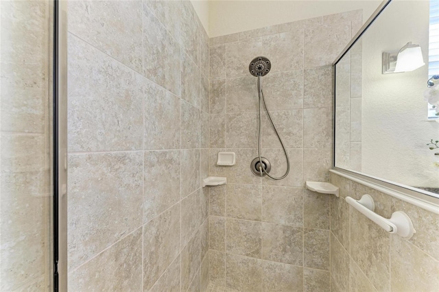 bathroom with tiled shower