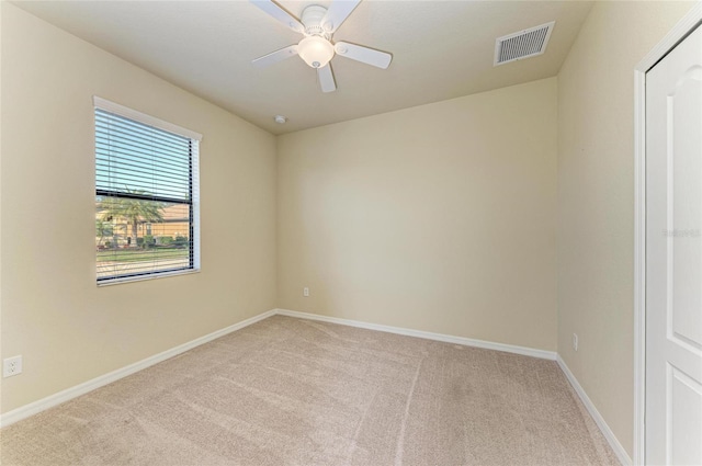 unfurnished room featuring light carpet and ceiling fan