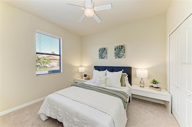 bedroom featuring light carpet, a closet, and ceiling fan