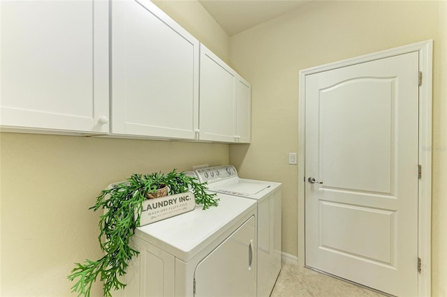 laundry area featuring cabinets, light tile patterned floors, and independent washer and dryer