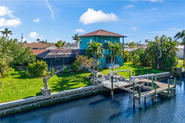 rear view of property with boat lift, a yard, a water view, and a lanai