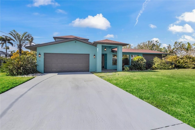 view of front of home featuring a garage, driveway, and a front yard