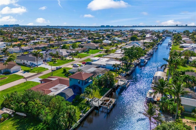 birds eye view of property with a water view and a residential view