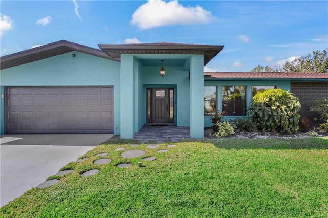 view of front of property with a front yard, brick siding, driveway, and an attached garage