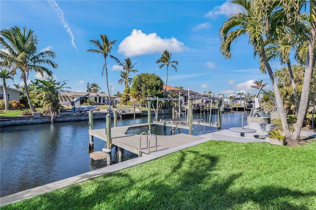 view of dock featuring a residential view, a water view, a lawn, and boat lift