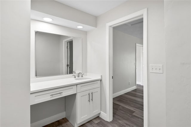 bathroom featuring recessed lighting, vanity, baseboards, and wood finished floors