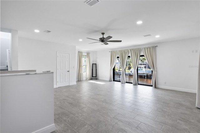 unfurnished living room featuring baseboards, visible vents, a ceiling fan, and recessed lighting