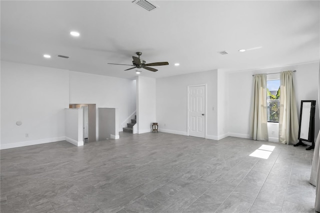 unfurnished living room featuring stairway, visible vents, and recessed lighting