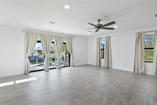 spare room with a water view, baseboards, visible vents, and recessed lighting