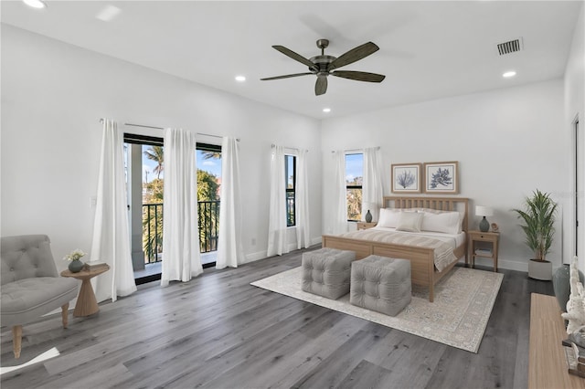 bedroom with dark wood-style flooring, recessed lighting, visible vents, and access to exterior