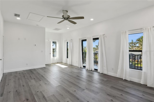 spare room featuring light wood finished floors, visible vents, and recessed lighting