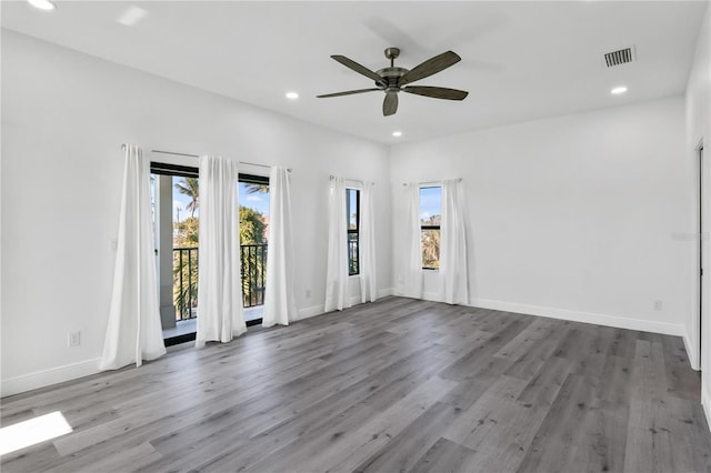 unfurnished room featuring light wood-style floors, recessed lighting, visible vents, and baseboards