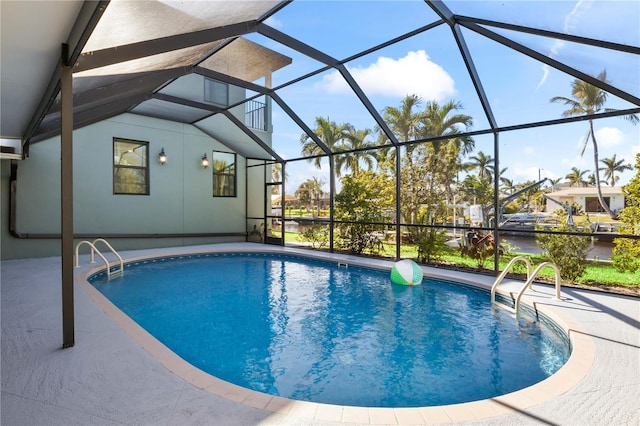 pool with glass enclosure and a patio